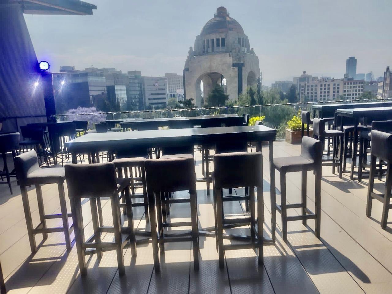Periqueras y mesas altas montadas en una terraza